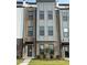 Charming townhome with brick and gray facade, modern windows, and well-maintained landscaping at 2908 Kempthorne Rd # 53, Cary, NC 27519