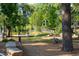Dog park with green space, walking path, benches, and trees, perfect for pets and their owners at 3104 Kempthorne Rd # 48, Cary, NC 27519