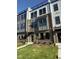 Modern townhome exterior featuring a brick facade, large windows, and manicured landscaping at 3104 Kempthorne Rd # 48, Cary, NC 27519