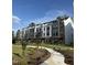 Modern townhouse exteriors feature beautiful landscaping, sidewalks, and a combination of siding and brick at 3104 Kempthorne Rd # 48, Cary, NC 27519