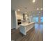 Modern kitchen with stainless steel appliances, a large kitchen island and beautiful hardwood floors at 3104 Kempthorne Rd # 48, Cary, NC 27519