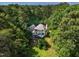 A beautiful aerial view of a well maintained home surrounded by mature trees, lawn and an outdoor patio at 3137 Falling Cedars Dr, Chapel Hill, NC 27516