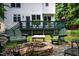 Backyard featuring a cozy fire pit area with Adirondack chairs and mature trees at 3137 Falling Cedars Dr, Chapel Hill, NC 27516