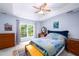 Comfortable bedroom featuring a tray ceiling, a large window, and lots of dresser storage at 3137 Falling Cedars Dr, Chapel Hill, NC 27516