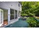 View of the backyard deck with outdoor seating and a doorway to the house at 3137 Falling Cedars Dr, Chapel Hill, NC 27516