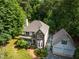 Attractive two-story home with brick accents, a charming front porch, landscaped yard, and detached two-car garage at 3137 Falling Cedars Dr, Chapel Hill, NC 27516