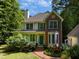 Attractive home with a brick walkway, covered porch, bay window, and lush landscaping at 3137 Falling Cedars Dr, Chapel Hill, NC 27516