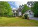 Charming two-story home featuring brick accents, a welcoming front porch, and a detached garage at 3137 Falling Cedars Dr, Chapel Hill, NC 27516