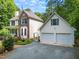 Exterior of a house with a detached two-car garage and a gravel driveway surrounded by landscaping at 3137 Falling Cedars Dr, Chapel Hill, NC 27516