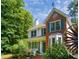 Traditional two-story home with green shutters, brick details, and a cozy front porch at 3137 Falling Cedars Dr, Chapel Hill, NC 27516