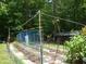 Backyard garden with a variety of plants, surrounded by lush trees and natural foliage at 3137 Falling Cedars Dr, Chapel Hill, NC 27516