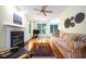 Inviting living room with fireplace, ceiling fan, and hardwood floors at 3137 Falling Cedars Dr, Chapel Hill, NC 27516