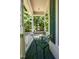 Cozy porch with metal table and chairs overlooking lush greenery at 3137 Falling Cedars Dr, Chapel Hill, NC 27516