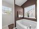 Bathroom featuring a soaking tub and large window at , Raleigh, NC 27610