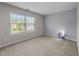 Cozy bedroom with a large window, carpeted floors, and a modern art piece at , Raleigh, NC 27610