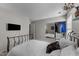 Cozy bedroom with a minimalist metal frame bed, tv and mirrored closet at , Raleigh, NC 27610