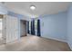 Bedroom with blue walls, carpeted floors, a mirrored closet, and a large window with curtains at , Raleigh, NC 27610