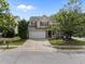 Charming home with a two-car garage, well-manicured lawn, and mature trees providing ample shade on a sunny day at , Raleigh, NC 27610