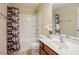Bathroom with shower and tub combination, patterned shower curtain, and white vanity at 413 Barnard Castle Ct, Rolesville, NC 27571