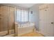 Bathroom featuring a corner tub and a separate shower at 413 Barnard Castle Ct, Rolesville, NC 27571