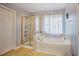 Bathroom featuring a corner tub and a separate shower at 413 Barnard Castle Ct, Rolesville, NC 27571