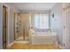 Bathroom featuring a corner tub and a separate shower at 413 Barnard Castle Ct, Rolesville, NC 27571