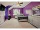Purple bedroom featuring a large window and desk area at 413 Barnard Castle Ct, Rolesville, NC 27571