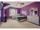 Purple bedroom featuring a large window and desk area at 413 Barnard Castle Ct, Rolesville, NC 27571