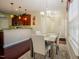Dining area with open view of kitchen, modern lighting, and warm wood floors at 413 Barnard Castle Ct, Rolesville, NC 27571