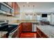 Open kitchen with stainless steel appliances, granite counters, and seamless flow to the living space at 413 Barnard Castle Ct, Rolesville, NC 27571