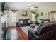 Inviting living room features a fireplace, ceiling fan, and comfortable leather seating arrangement at 413 Barnard Castle Ct, Rolesville, NC 27571