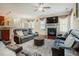 Comfortable living room features a fireplace, ceiling fan and plush leather seating for relaxing at 413 Barnard Castle Ct, Rolesville, NC 27571