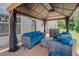 Cozy outdoor lounge area with comfortable seating and covered pergola at 413 Barnard Castle Ct, Rolesville, NC 27571