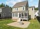 Backyard with patio, fire pit, green lawn, and a screened-in porch at 418 Wyndham Drive, Chapel Hill, NC 27516