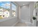 Bright bathroom with tub shower and view overlooking the houses nearby at 418 Wyndham Drive, Chapel Hill, NC 27516
