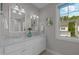 Well-lit bathroom with dual vanity, tile floors and a window overlooking the neighborhood at 418 Wyndham Drive, Chapel Hill, NC 27516