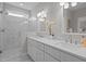 Modern bathroom with dual vanity, marble floors, granite countertop and a glass enclosed shower at 418 Wyndham Drive, Chapel Hill, NC 27516