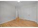 Empty bedroom with light gray walls, hardwood floors, ceiling fan and white trim at 418 Wyndham Drive, Chapel Hill, NC 27516