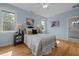 Cozy bedroom with light blue walls, hardwood floors, ceiling fan, and natural light at 418 Wyndham Drive, Chapel Hill, NC 27516