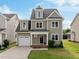 Charming two-story home with a landscaped front yard and a two-car garage and inviting front porch at 418 Wyndham Drive, Chapel Hill, NC 27516
