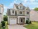 Charming two-story home with a landscaped front yard, a two-car garage, and an inviting front porch at 418 Wyndham Drive, Chapel Hill, NC 27516