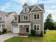 Charming two-story home with a well-manicured lawn and attached garage at 418 Wyndham Drive, Chapel Hill, NC 27516