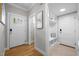 Inviting foyer with hardwood floors, coat storage bench, and a view to the house's front door at 418 Wyndham Drive, Chapel Hill, NC 27516