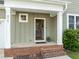 Inviting front porch with brick steps and modern home number display at 418 Wyndham Drive, Chapel Hill, NC 27516