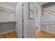 Hallway with closet and stairway access, featuring hardwood floors and an area for hanging art at 418 Wyndham Drive, Chapel Hill, NC 27516