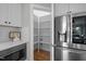 Well-organized pantry next to a modern refrigerator and built-in microwave in the kitchen at 418 Wyndham Drive, Chapel Hill, NC 27516
