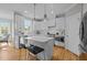 Modern kitchen featuring white cabinets, stainless steel appliances, and an island with barstool seating at 418 Wyndham Drive, Chapel Hill, NC 27516