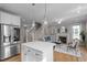 Open-concept living area showcasing the kitchen island, fireplace, and comfortable seating at 418 Wyndham Drive, Chapel Hill, NC 27516