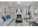 Cozy living room featuring a fireplace, neutral walls, ceiling fan and tasteful furnishings at 418 Wyndham Drive, Chapel Hill, NC 27516