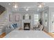 Living room with a fireplace, ceiling fan, modern decor, and an open view to the kitchen at 418 Wyndham Drive, Chapel Hill, NC 27516